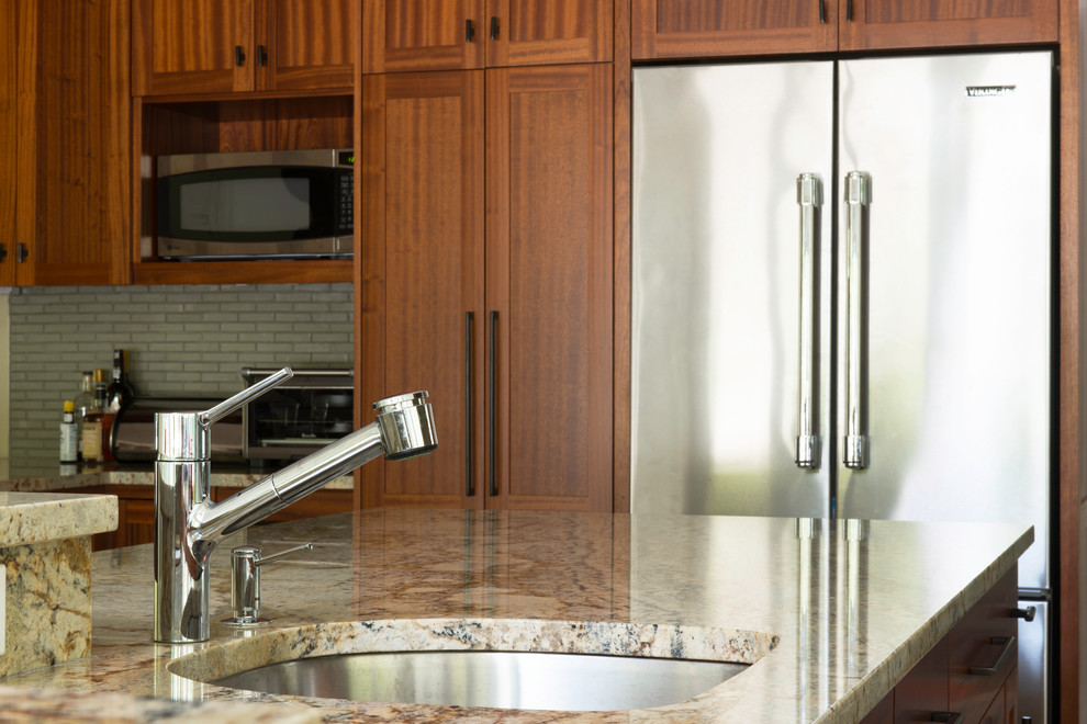 Eat-in kitchen - large transitional u-shaped eat-in kitchen idea in Boston with an undermount sink, flat-panel cabinets, dark wood cabinets, granite countertops, gray backsplash, stainless steel appliances and an island