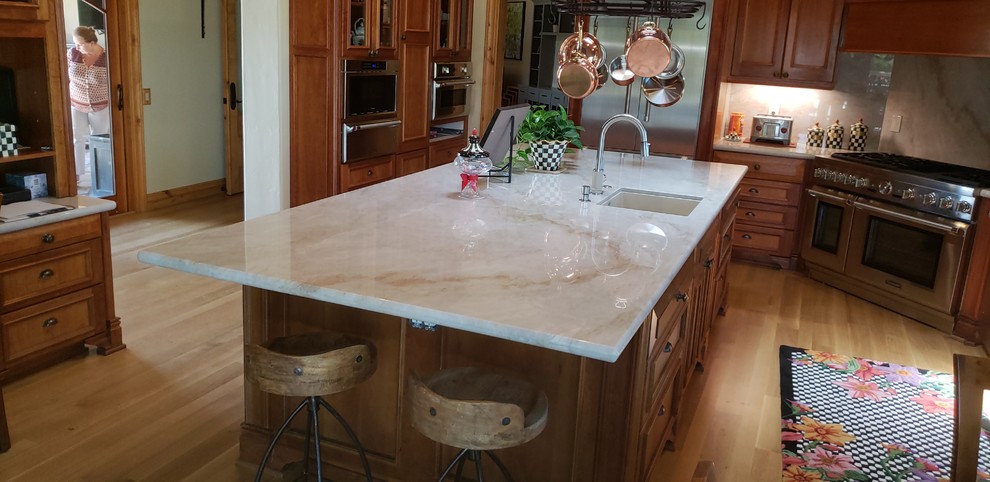 Inspiration for a kitchen in San Luis Obispo with quartzite benchtops, beige splashback, stone slab splashback, stainless steel appliances, with island and beige benchtop.