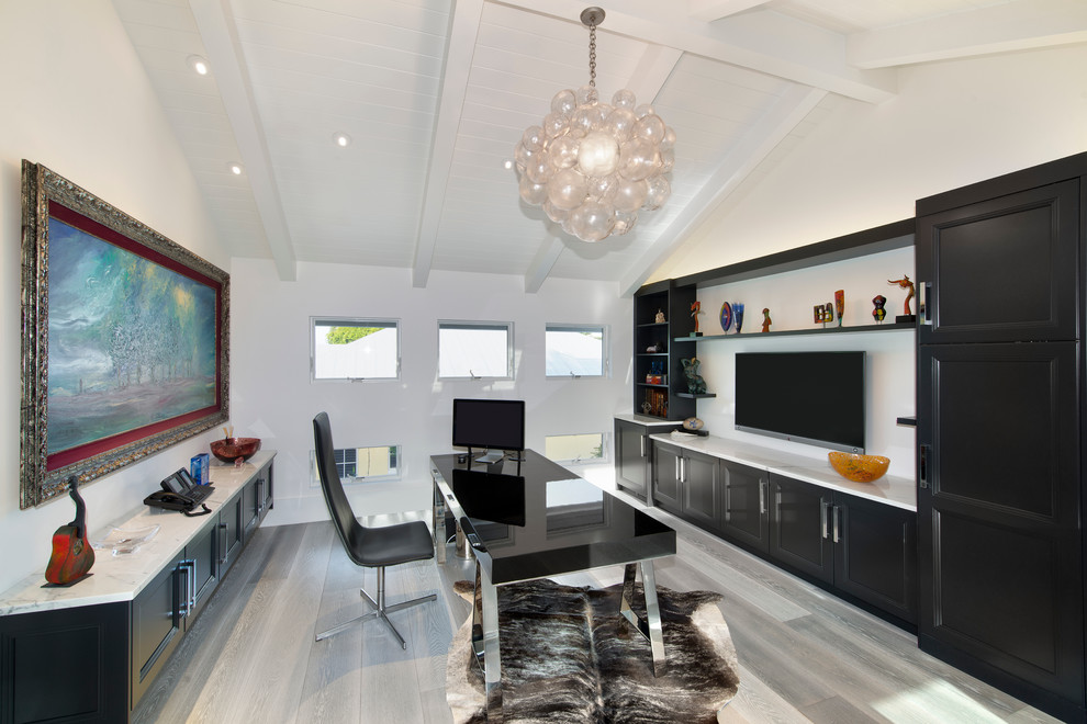Mid-sized trendy freestanding desk medium tone wood floor and gray floor study room photo in Miami with white walls
