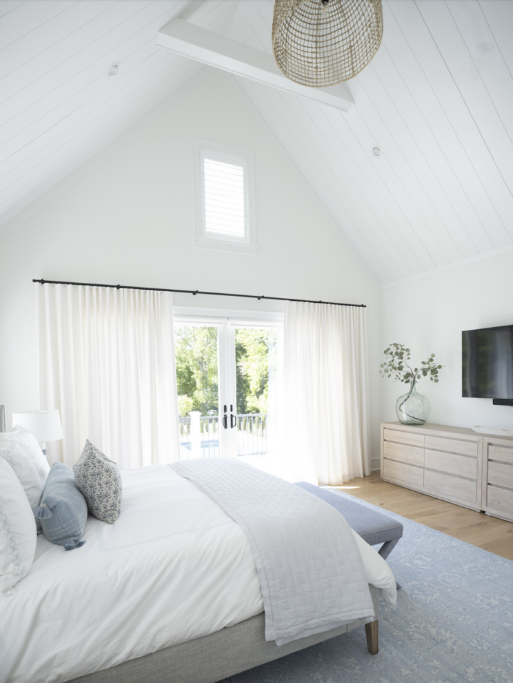 This is an example of an expansive modern master bedroom in Other with white walls, light hardwood flooring, brown floors and a timber clad ceiling.