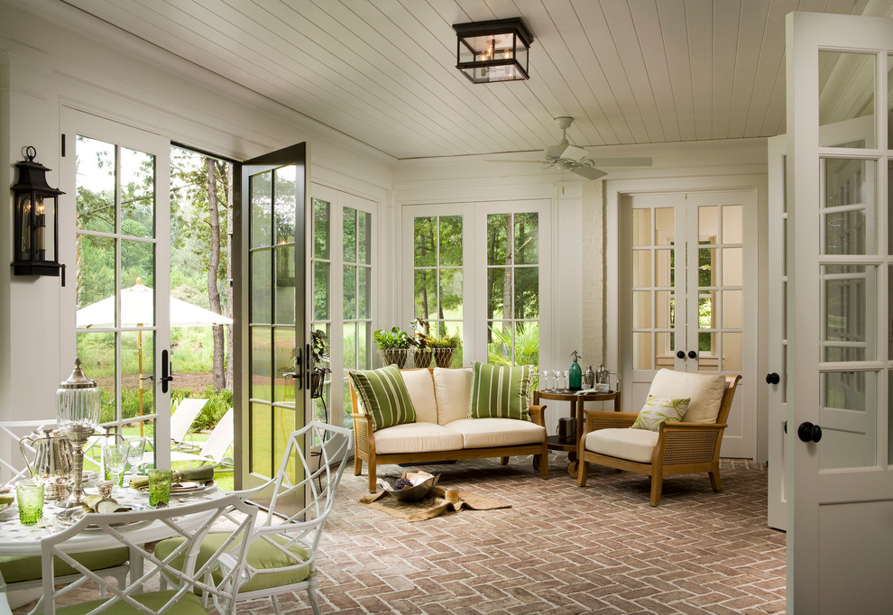 Design ideas for a country sunroom in Atlanta with red floor.