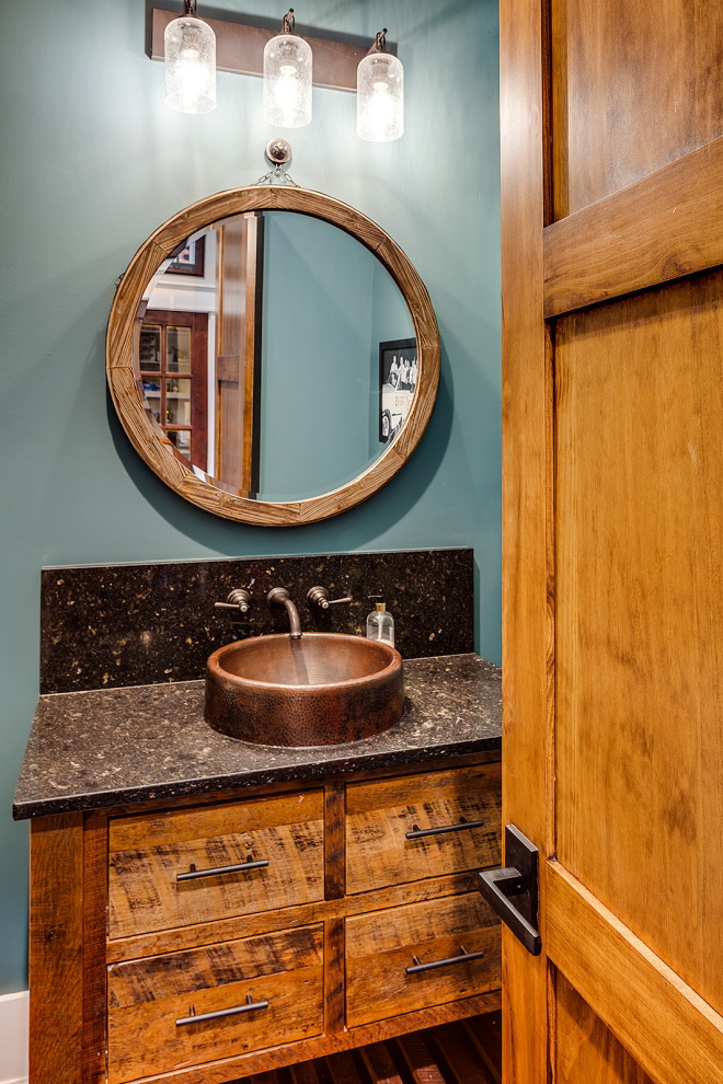 Mid-sized country powder room in Other with shaker cabinets, medium wood cabinets, blue walls, a vessel sink and multi-coloured benchtops.