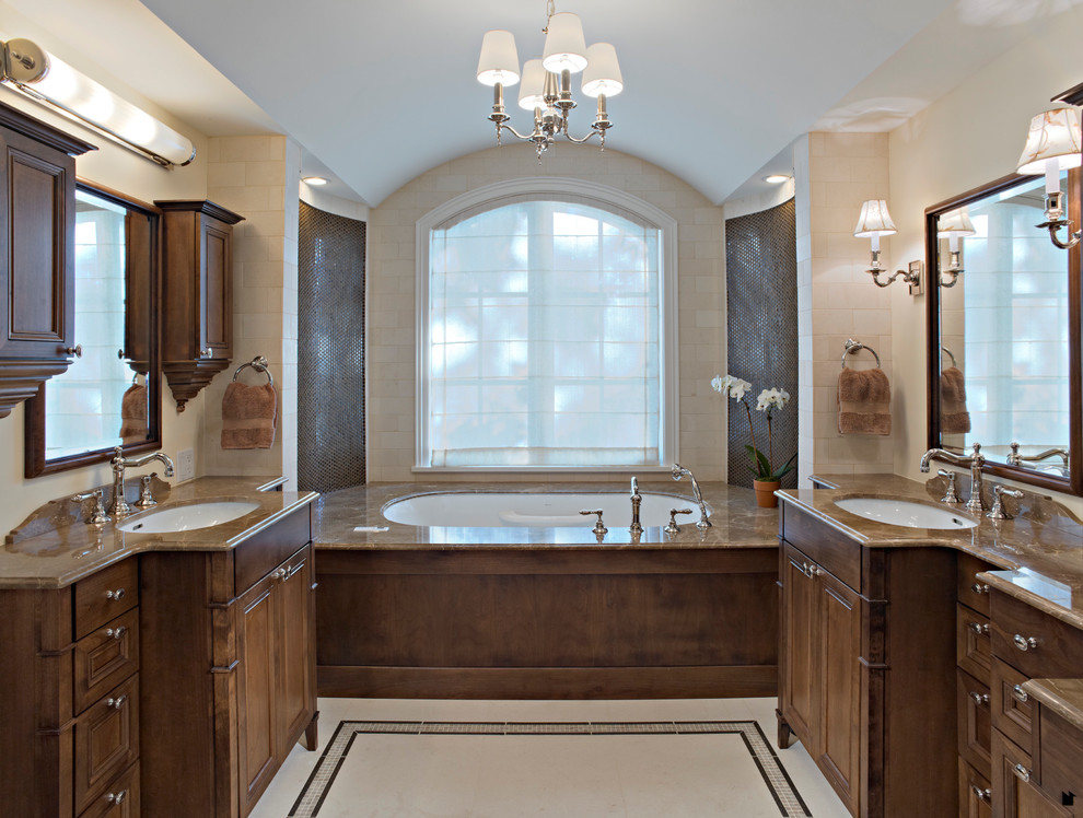Photo of a traditional bathroom in Chicago with an alcove tub and dark wood cabinets.