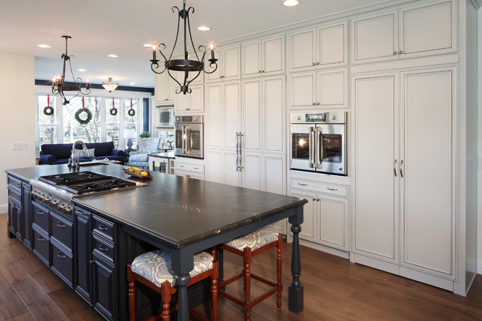 Inspiration for a traditional open plan kitchen in Denver with a single-bowl sink, beaded inset cabinets, white cabinets, dark hardwood floors, with island and brown floor.