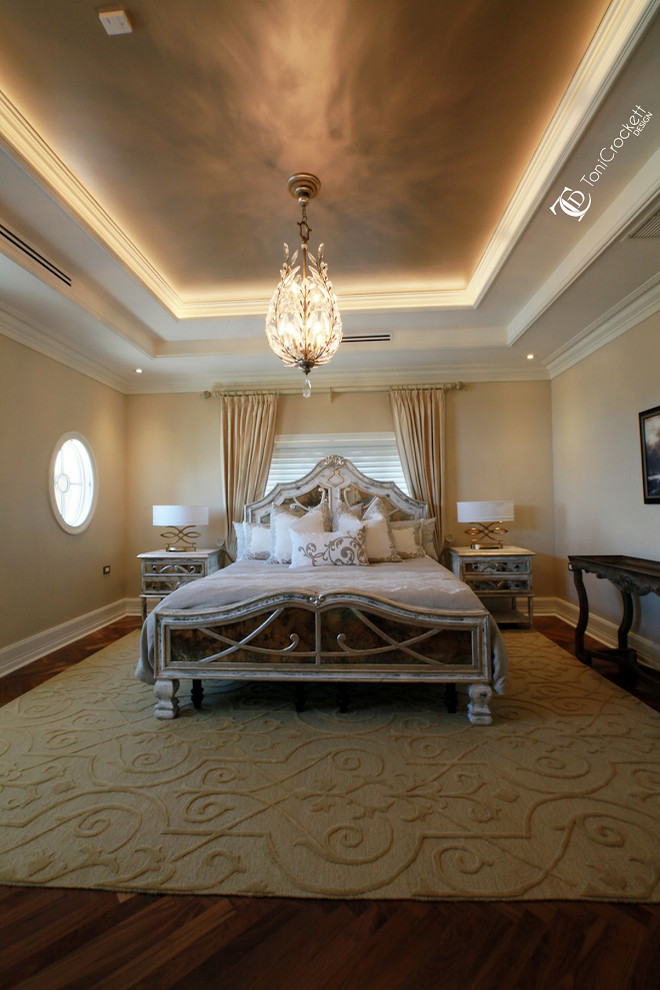 This is an example of an expansive traditional guest bedroom in Other with beige walls and medium hardwood floors.