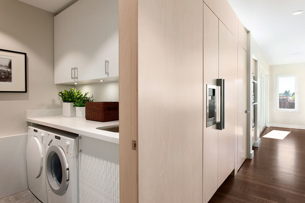 Design ideas for a contemporary laundry room in Vancouver with beige walls and white benchtop.