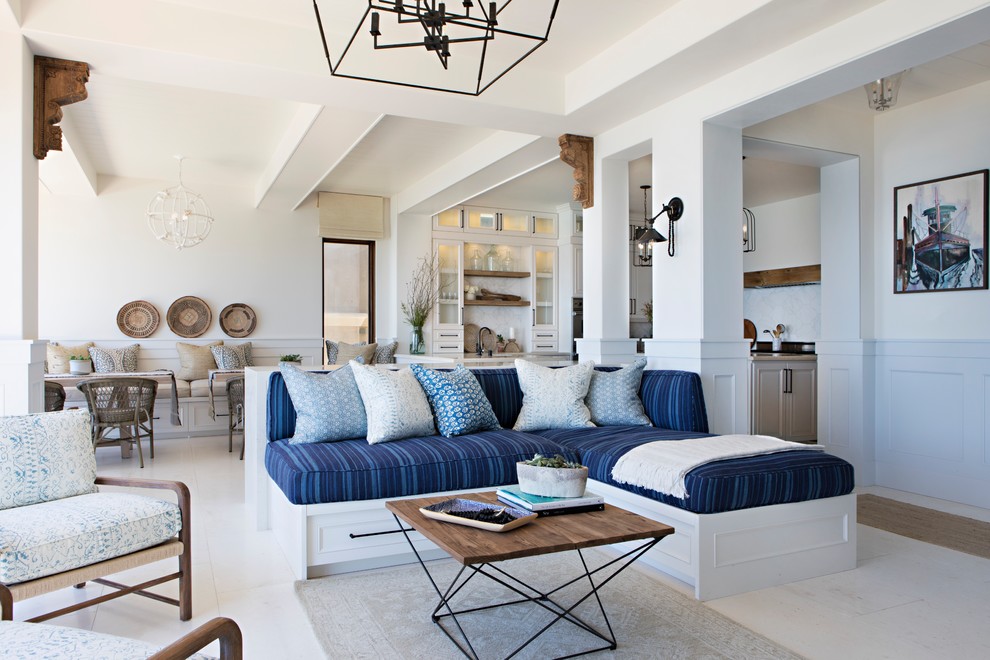 Beach style open concept family room in San Diego with white walls and beige floor.