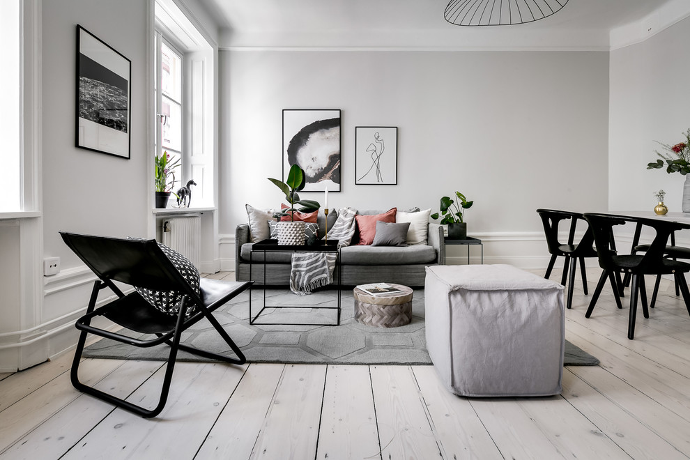 Inspiration for a mid-sized scandinavian formal open concept living room in Stockholm with grey walls, light hardwood floors and beige floor.