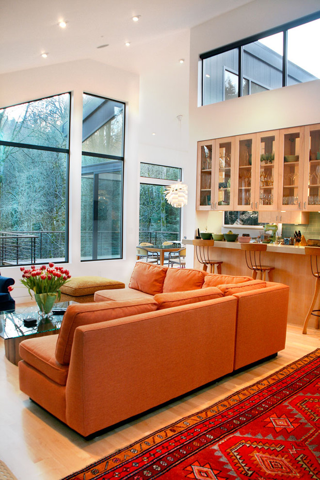 Photo of a contemporary open concept living room in Portland with white walls.