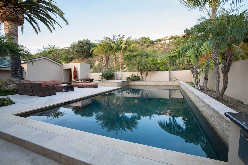 Photo of a large contemporary backyard rectangular pool in San Diego with a hot tub and concrete slab.