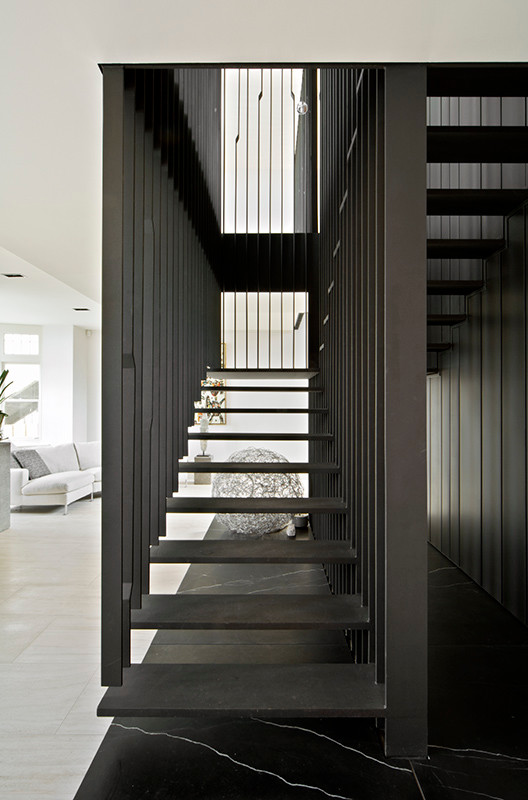 Design ideas for a contemporary staircase in Melbourne with metal risers and metal railing.