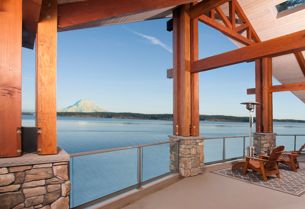 Inspiration for a large traditional backyard deck in Seattle with a roof extension.