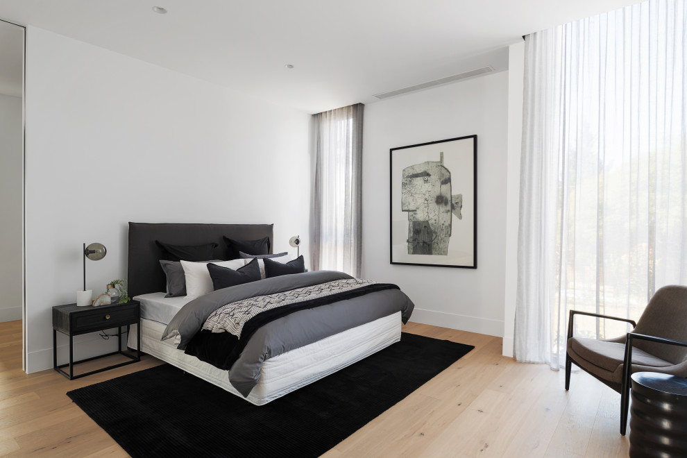 Design ideas for a mid-sized contemporary master bedroom in Melbourne with white walls, light hardwood floors and beige floor.