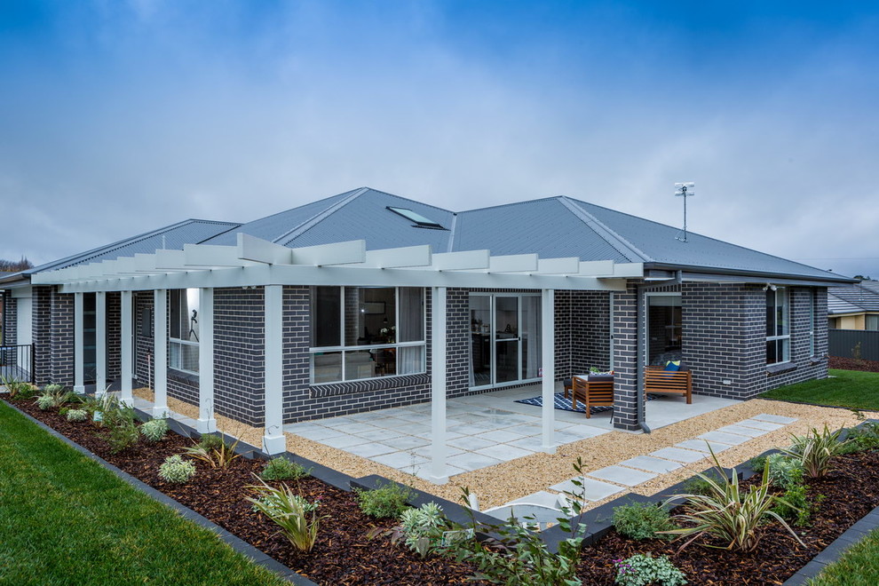 Photo of a large transitional brick grey exterior in Melbourne.