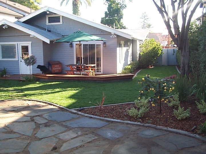 Photo of a mid-sized traditional backyard patio in San Diego with a pergola and natural stone pavers.