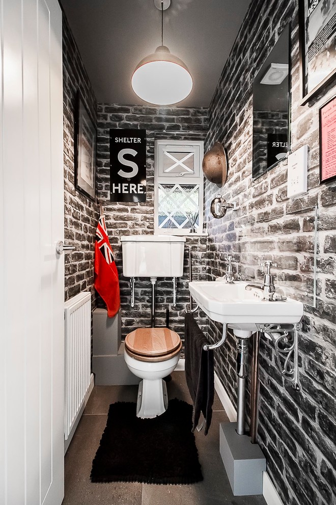 Design ideas for a small eclectic powder room in London with a one-piece toilet, brown tile, white walls, slate floors, grey floor and a wall-mount sink.