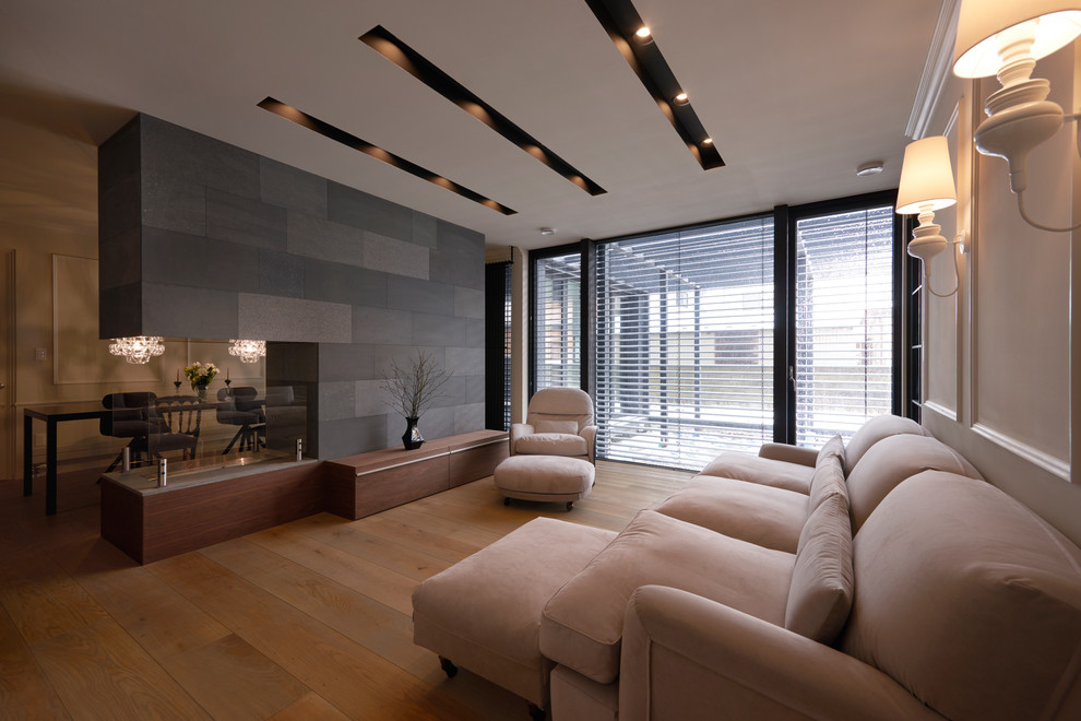 Photo of a contemporary living room in Other with white walls, medium hardwood floors and brown floor.