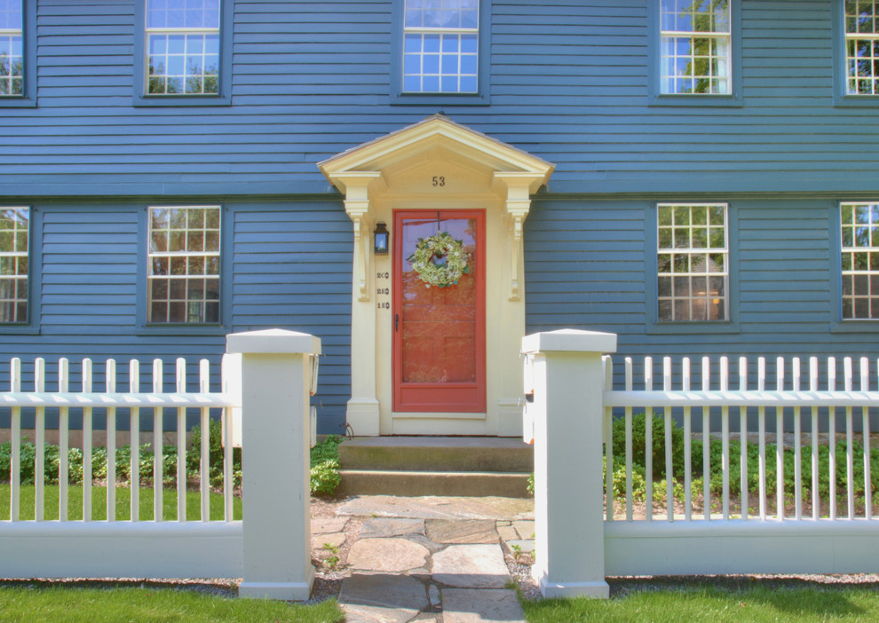 Traditional entryway in Bridgeport with a red front door.