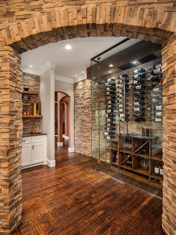 Small traditional wine cellar in Dallas with medium hardwood floors and display racks.