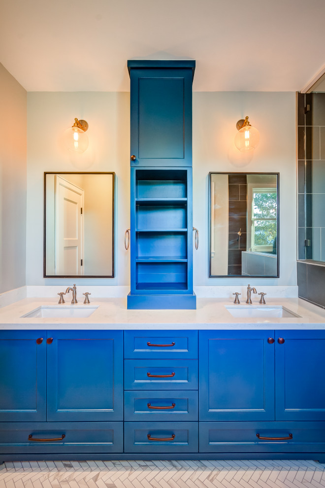 This is an example of a small eclectic master bathroom in Houston with shaker cabinets, blue cabinets, an open shower, gray tile, porcelain tile, engineered quartz benchtops, white benchtops, a double vanity, a built-in vanity, a one-piece toilet, grey walls, mosaic tile floors, an undermount sink, grey floor, an open shower and a shower seat.