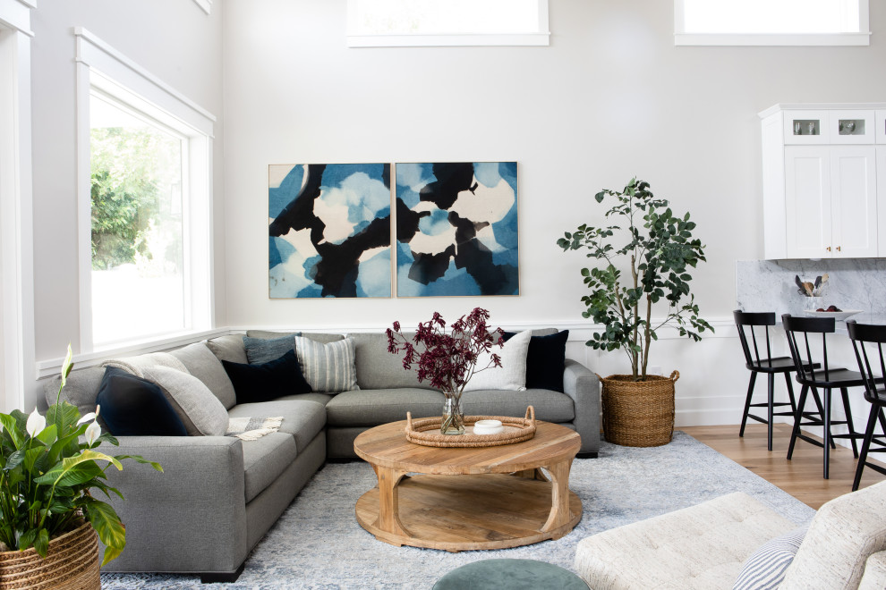 Living room - large coastal open concept light wood floor living room idea in Los Angeles with gray walls and no fireplace