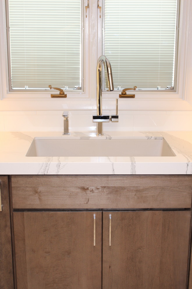 Open concept kitchen - mid-sized transitional u-shaped ceramic tile open concept kitchen idea in Phoenix with an undermount sink, flat-panel cabinets, gray cabinets, quartz countertops, white backsplash, porcelain backsplash, stainless steel appliances and a peninsula