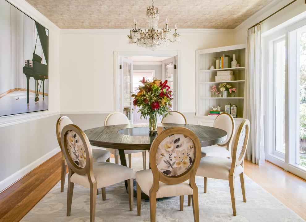 Photo of a transitional separate dining room in San Francisco with white walls, medium hardwood floors, brown floor and decorative wall panelling.