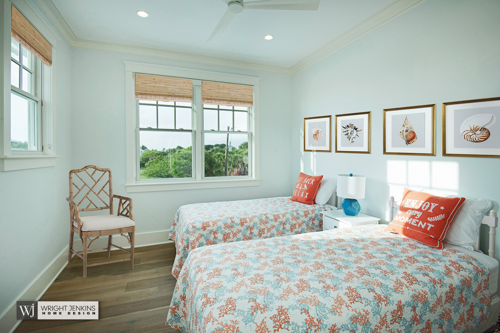 This is an example of a mid-sized beach style guest bedroom in Miami with blue walls, light hardwood floors, no fireplace and beige floor.