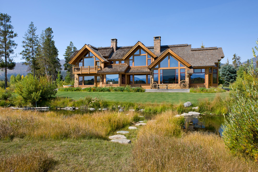 Example of a mountain style two-story wood gable roof design