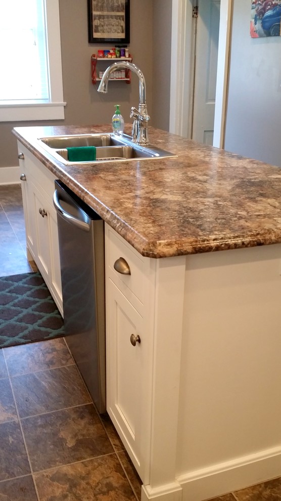 Photo of a mid-sized traditional l-shaped separate kitchen in Other with a double-bowl sink, beaded inset cabinets, white cabinets, laminate benchtops, stainless steel appliances, ceramic floors and with island.