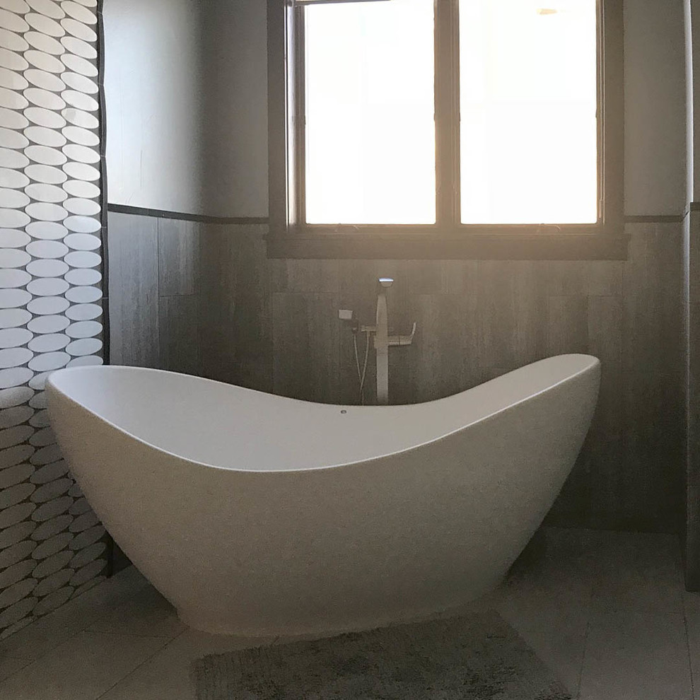 Mid-sized transitional master white tile and porcelain tile porcelain tile freestanding bathtub photo with recessed-panel cabinets, gray cabinets, a two-piece toilet, white walls, an undermount sink and granite countertops