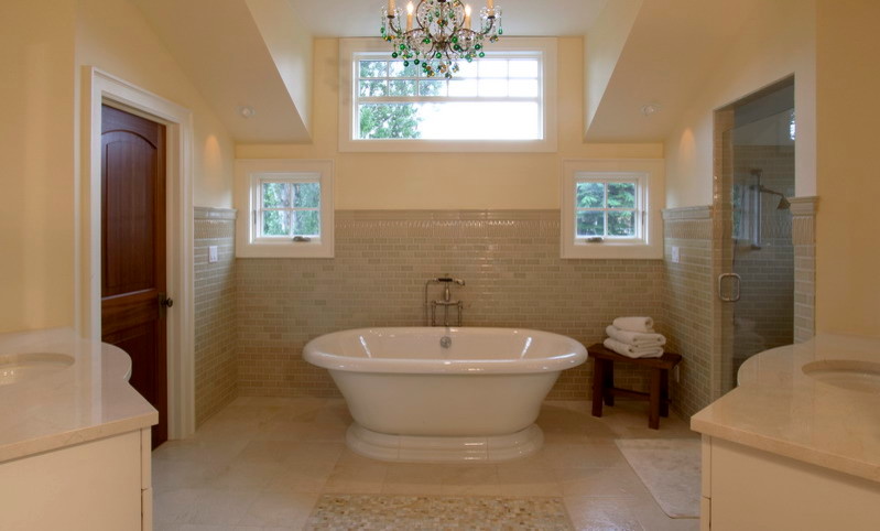 Large transitional master beige tile and porcelain tile limestone floor freestanding bathtub photo in Seattle with an undermount sink, flat-panel cabinets, limestone countertops, a two-piece toilet and beige walls