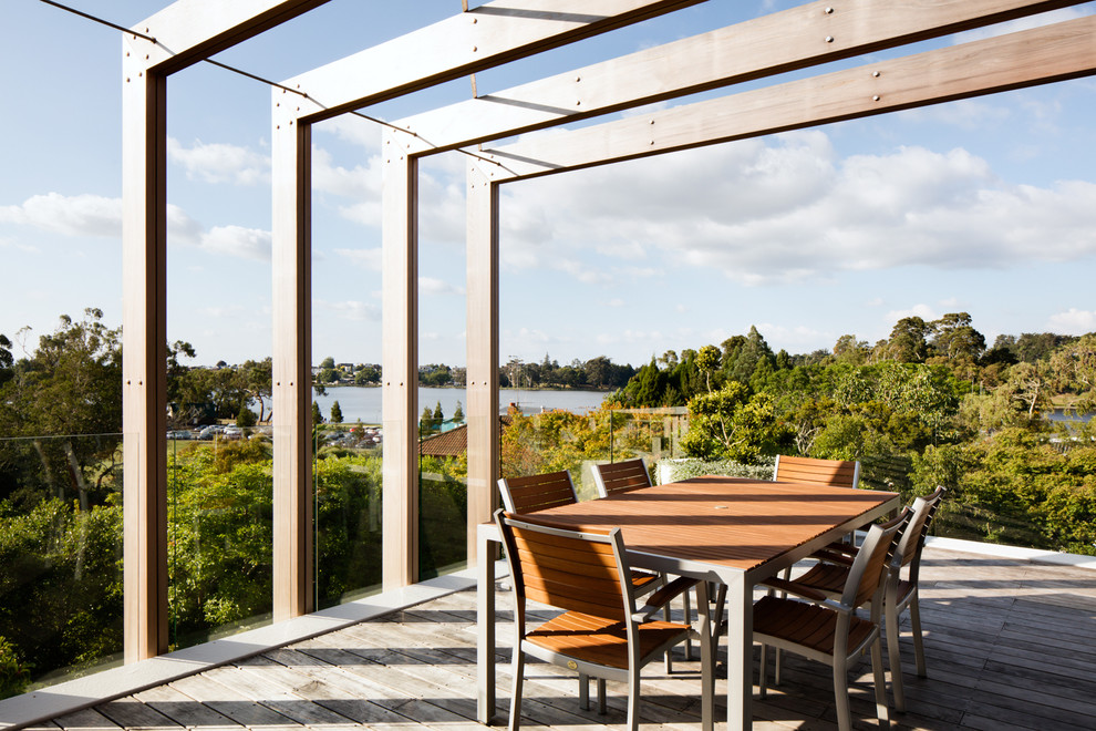 This is an example of a contemporary balcony in Hamilton with a pergola.