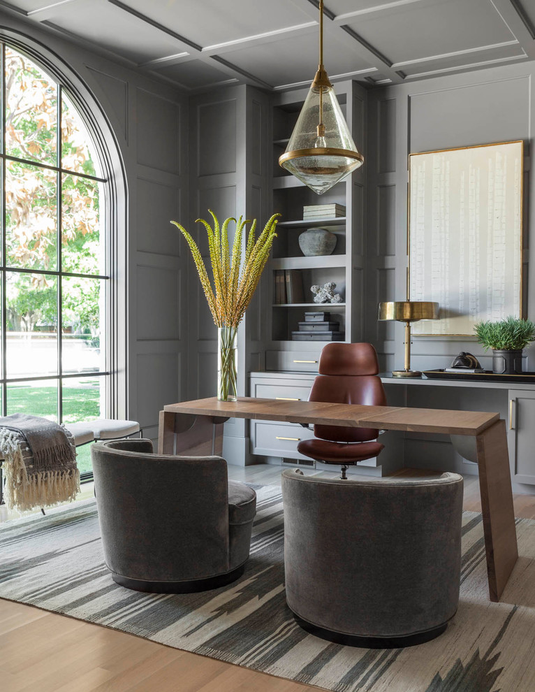 Transitional freestanding desk light wood floor and brown floor study room photo in Dallas with gray walls and no fireplace
