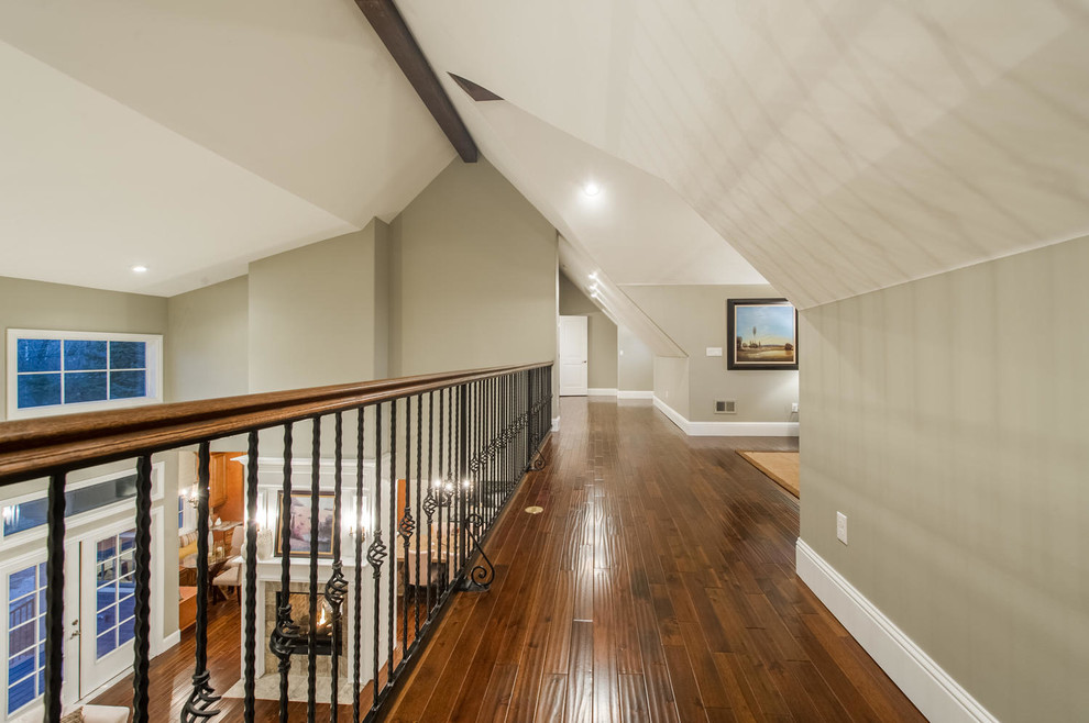 This is an example of a mid-sized transitional hallway in Denver with grey walls and dark hardwood floors.