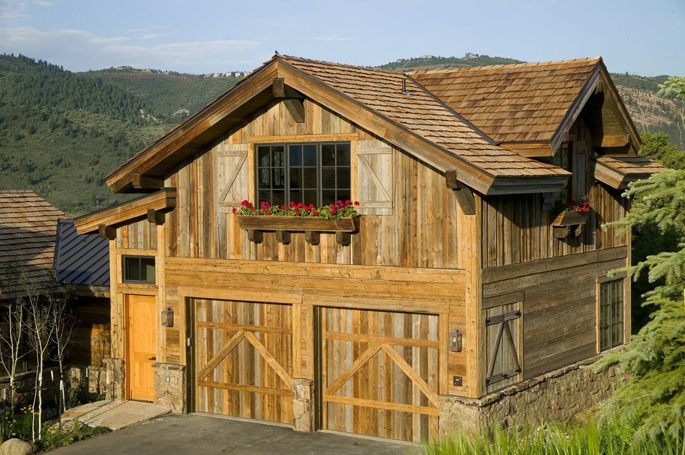 This is an example of a country two-storey exterior in Denver with wood siding.