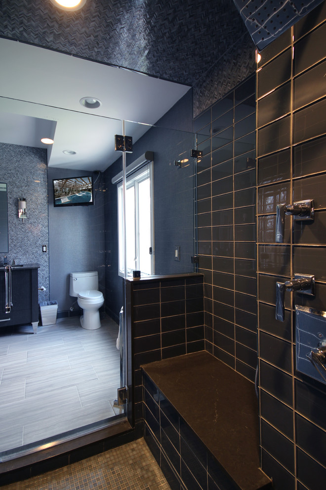 Photo of a mid-sized contemporary master bathroom in New York with flat-panel cabinets, dark wood cabinets, a freestanding tub, a corner shower, black tile, black and white tile, gray tile, glass tile, grey walls, ceramic floors, an undermount sink and solid surface benchtops.