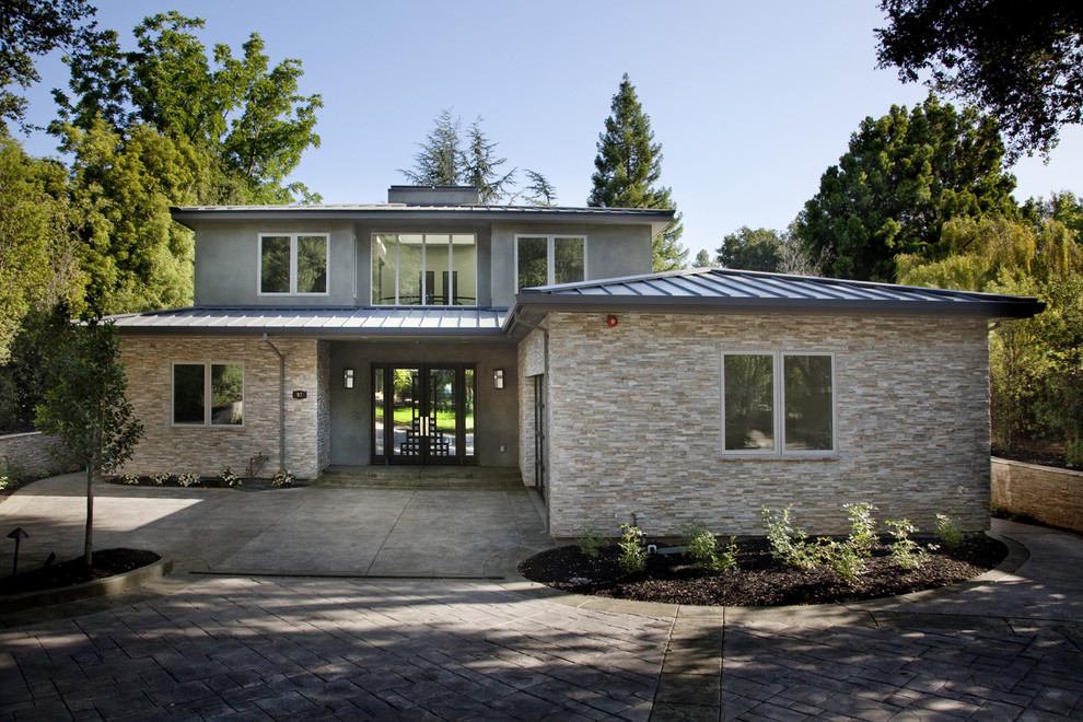 This is an example of a contemporary two-storey exterior in San Francisco with stone veneer.