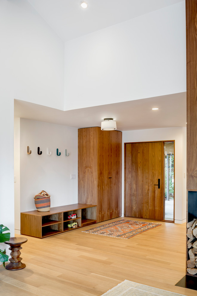 Inspiration for a mid-sized midcentury front door in Portland with white walls, light hardwood floors, a single front door and a medium wood front door.