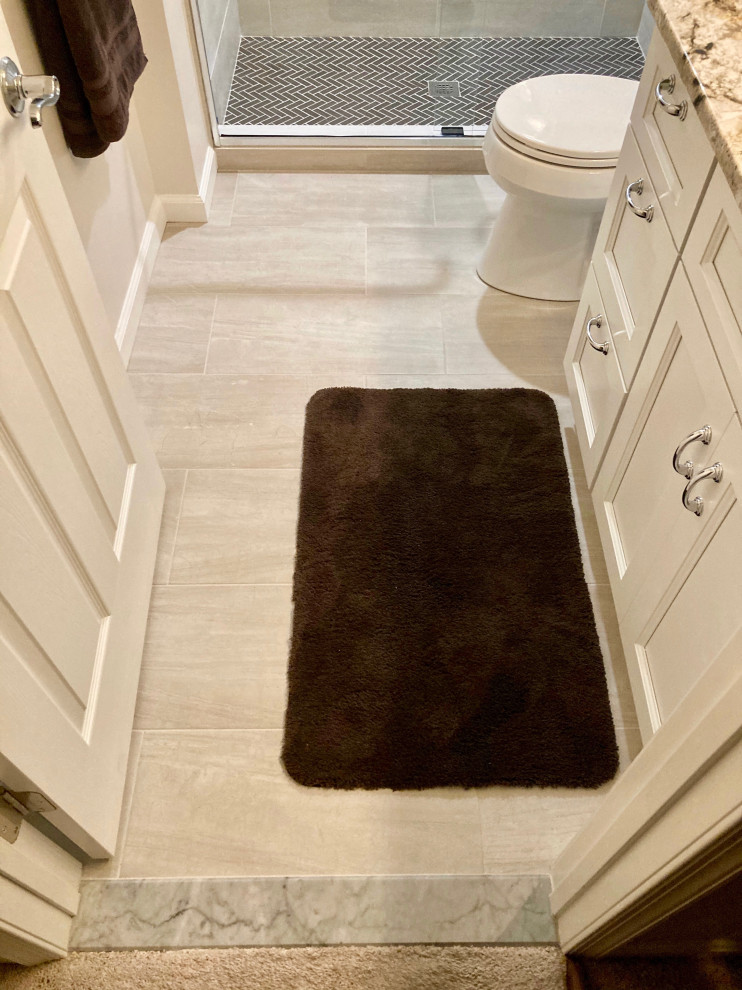 This is an example of a medium sized modern family bathroom in DC Metro with recessed-panel cabinets, white cabinets, an alcove shower, a two-piece toilet, brown tiles, porcelain tiles, yellow walls, porcelain flooring, a submerged sink, quartz worktops, brown floors, a sliding door, brown worktops, a single sink and a built in vanity unit.