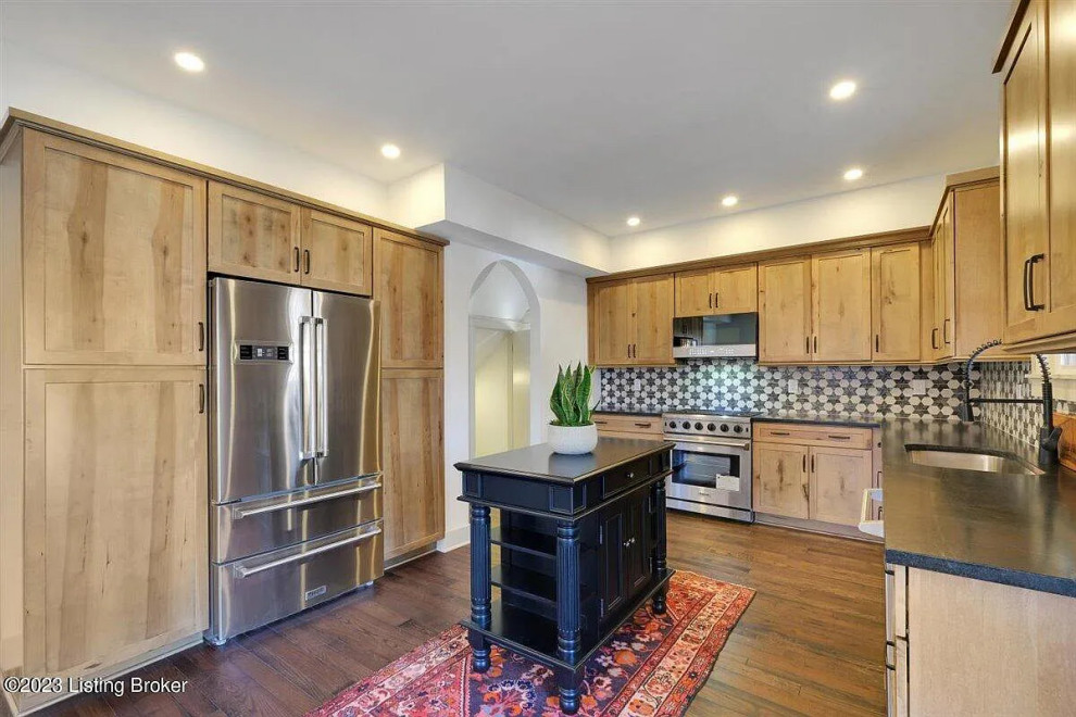 Inspiration for a mid-sized transitional l-shaped medium tone wood floor kitchen remodel with an undermount sink, shaker cabinets, light wood cabinets and an island