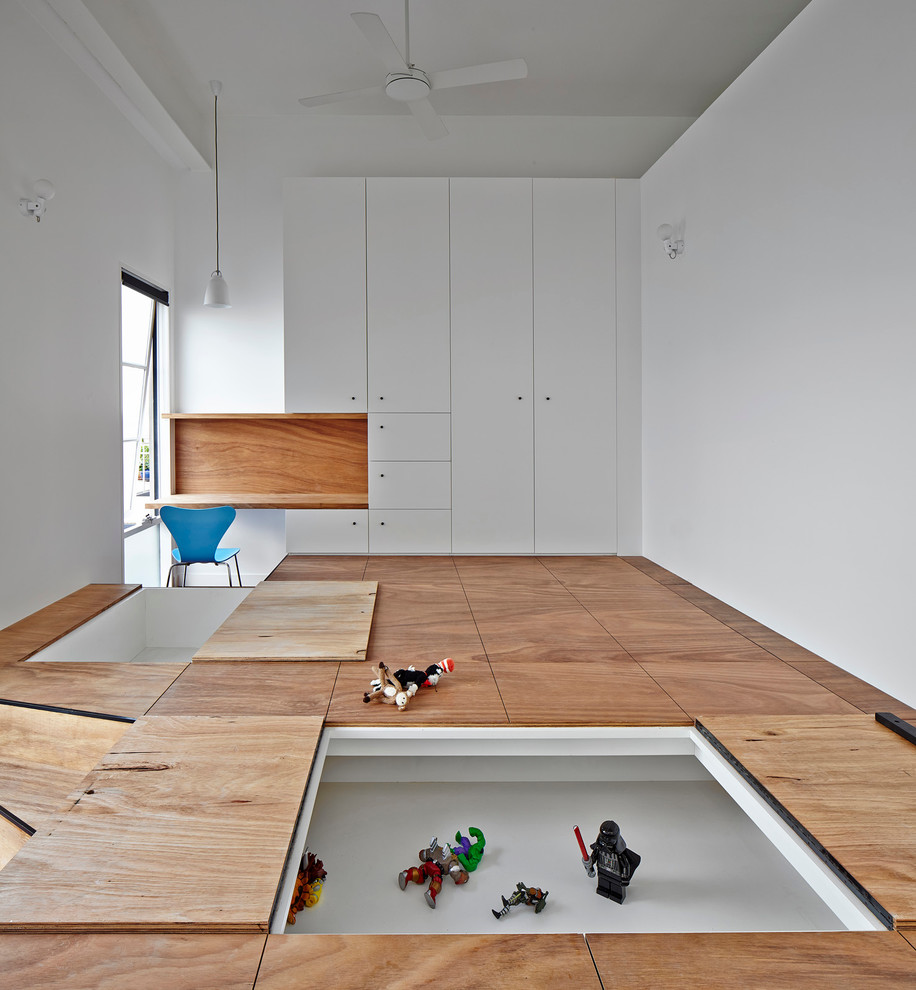 Inspiration for a large contemporary kids' room for boys in Melbourne with white walls and light hardwood floors.