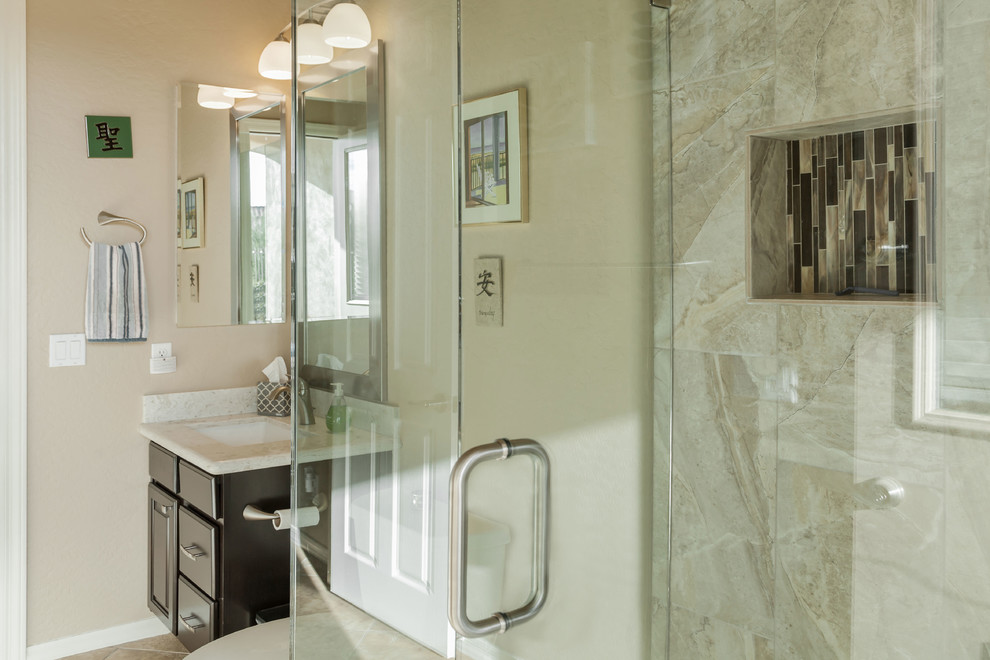 Example of a mid-sized transitional kids' brown tile ceramic tile corner shower design in Phoenix with a two-piece toilet, beige walls, an undermount sink and quartz countertops
