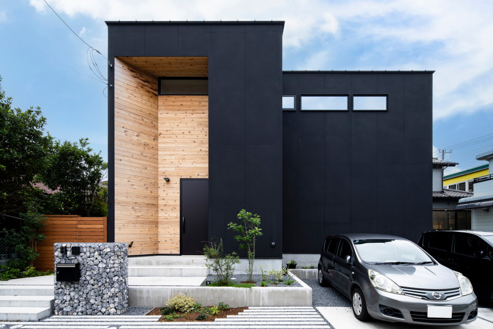 Zweistöckiges Modernes Einfamilienhaus mit schwarzer Fassadenfarbe in Sonstige