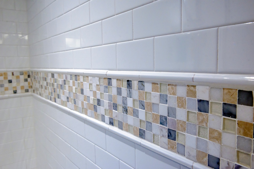 Example of a transitional beige tile marble floor corner shower design in Atlanta with an undermount sink, marble countertops and white walls