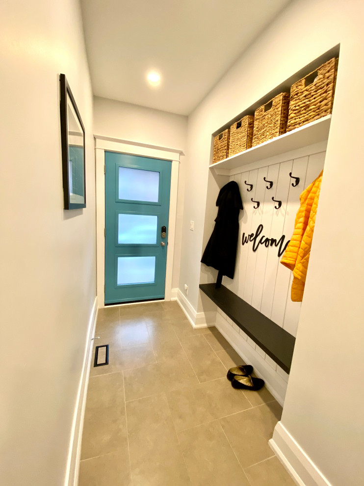 Mid-sized contemporary mudroom in Toronto with white walls, porcelain floors, a single front door, a blue front door, beige floor and planked wall panelling.