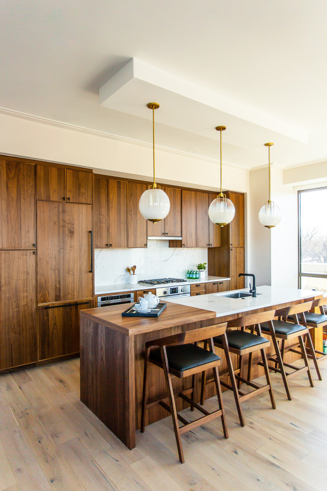 Mid-sized contemporary single-wall eat-in kitchen in DC Metro with an undermount sink, shaker cabinets, medium wood cabinets, wood benchtops, white splashback, stone slab splashback, stainless steel appliances, vinyl floors, with island, grey floor and multi-coloured benchtop.