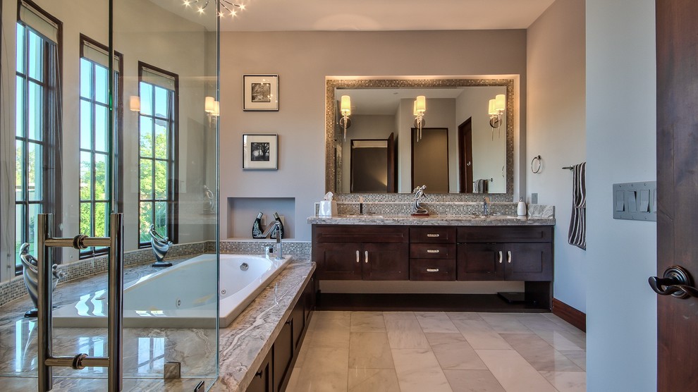 Photo of a mediterranean bathroom in Phoenix with shaker cabinets, dark wood cabinets, a freestanding tub, a corner shower, a two-piece toilet, mosaic tile, beige walls, an undermount sink and soapstone benchtops.