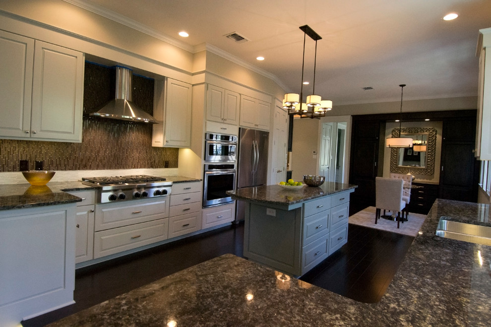 Inspiration for a large transitional u-shaped dark wood floor open concept kitchen remodel in Austin with an undermount sink, raised-panel cabinets, white cabinets, granite countertops, brown backsplash, glass tile backsplash, stainless steel appliances and an island
