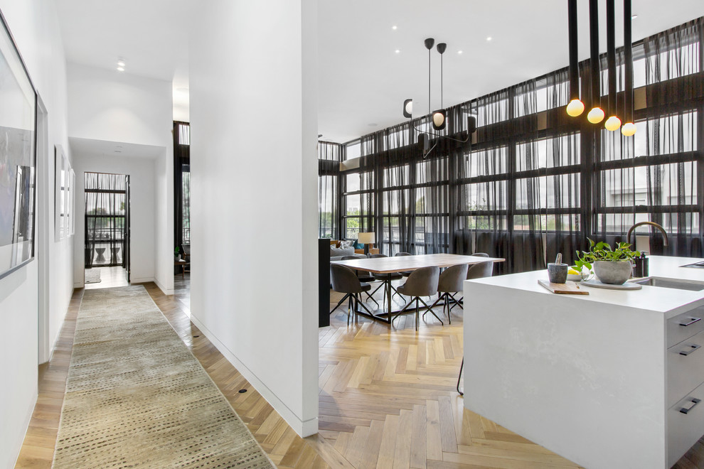 Inspiration for a contemporary open plan dining in Melbourne with white walls, light hardwood floors and beige floor.